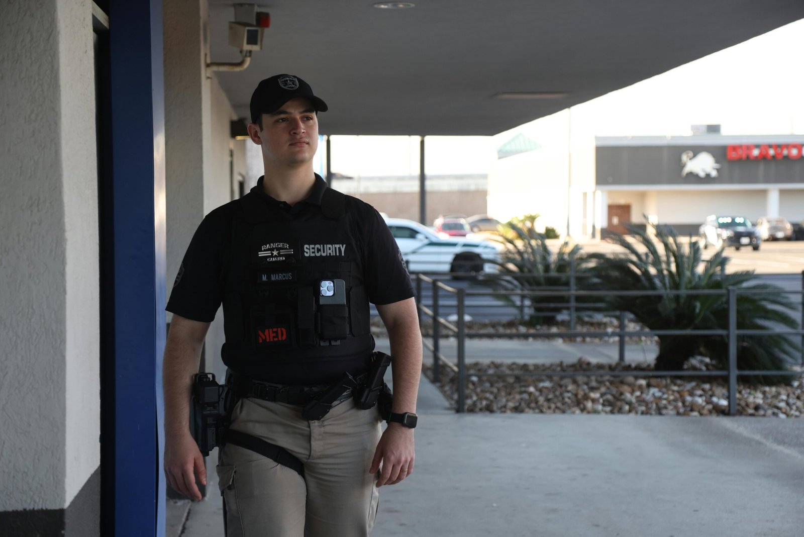 A security guard patrolling an outdoor area in League City, Texas, ensuring safety during the day.